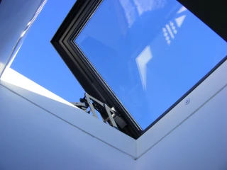 open rooflight showing blue sky through