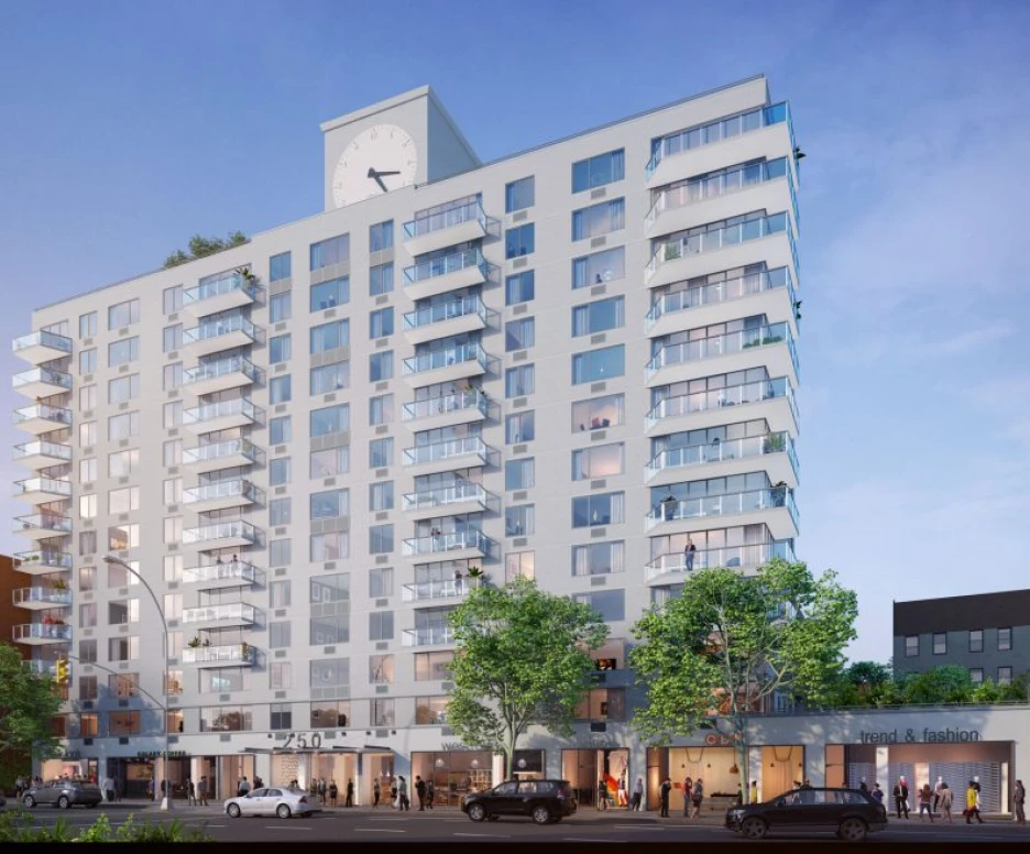 A modern multi-story residential building featuring a large clock on the facade. The design includes balconies on each floor and commercial spaces at the ground level. Surrounding trees and the street add to the urban atmosphere.