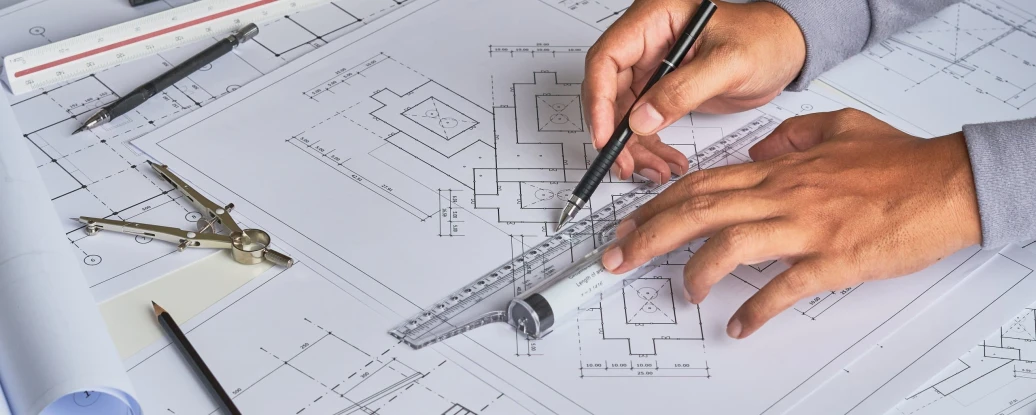 Architecture pictures with a hands hand holding a ruler and pen