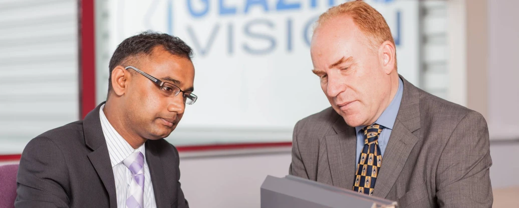 two men look at a piece of skylight
