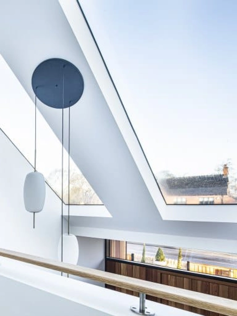 White walls and white carpets which is being highlighted more by the skylights letting natural light in