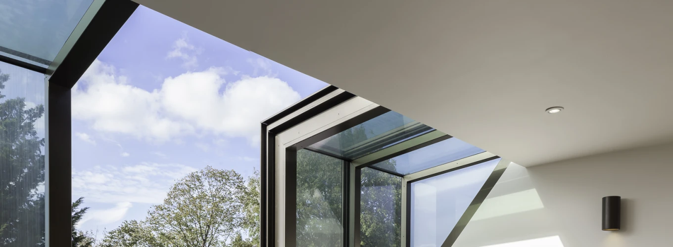 shows a large open room with an opening skylight and two chairs either side